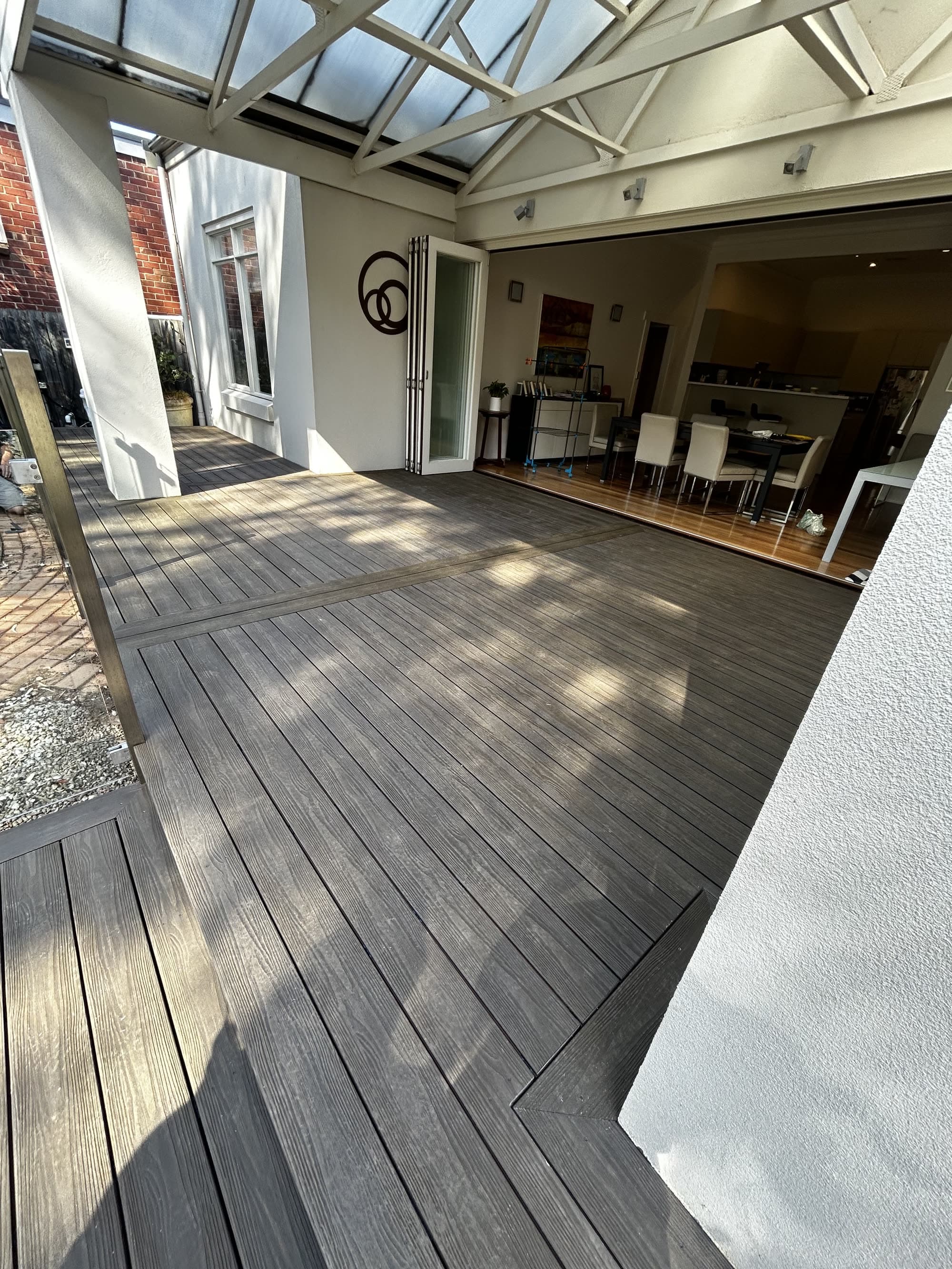 Grey composite deck laid outside a conservatory