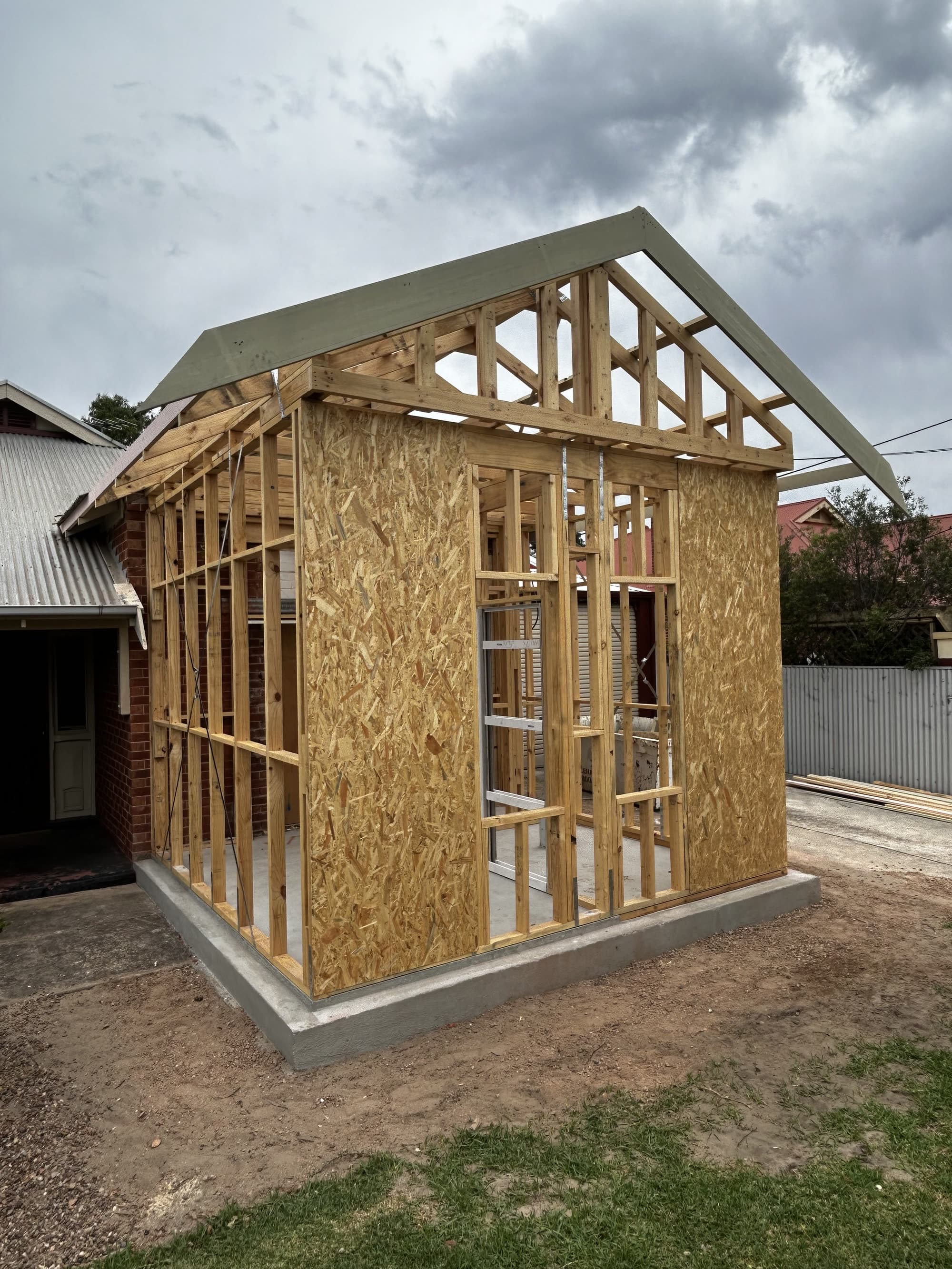 Timber-framed garage extension with gable trusses
