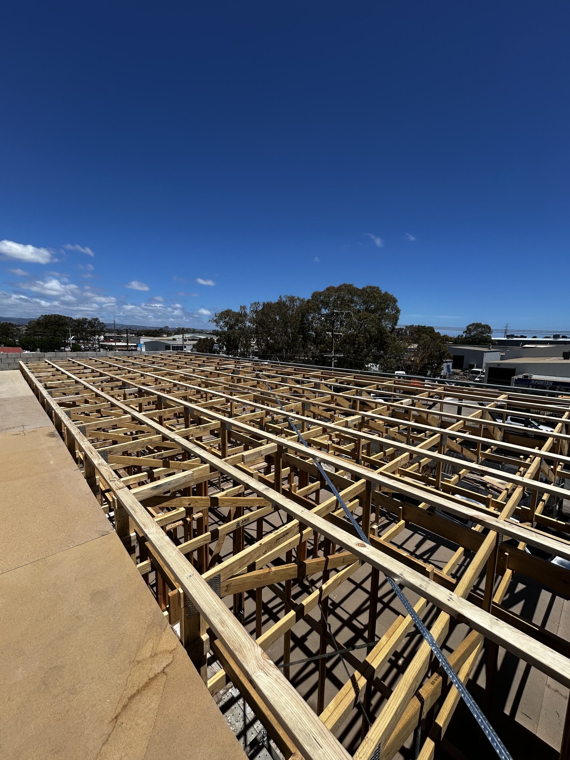 Timber bearers and joists laid out across a large subfloor