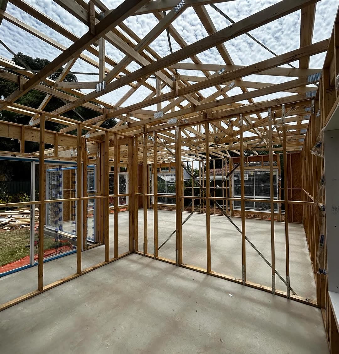 Timber wall frames and roof trusses inside an Adelaide extension at first fix stage